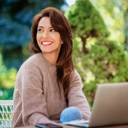 Latina woman with great skin outside smiling